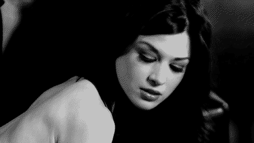 Brunette Babe's Sultry Stare: A Tantalizing Tale GIF